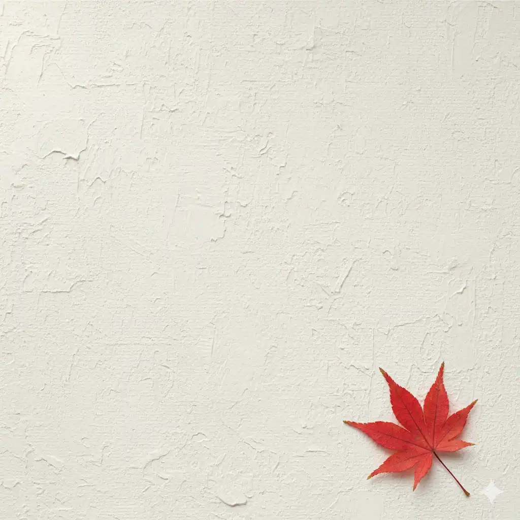 粗糙米白畫布背景，右下角一片精緻紅色楓葉，左上方柔和漫射光，大量留白。